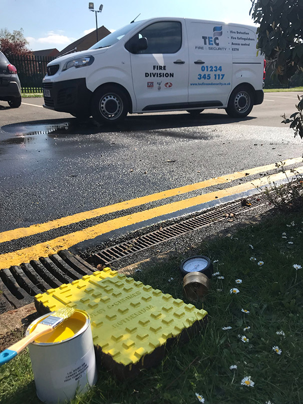 Painting fire hydrant cover with canary yellow paint